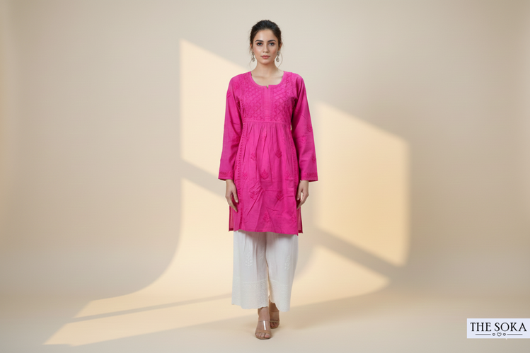 Woman wearing a pink chikankari kurti